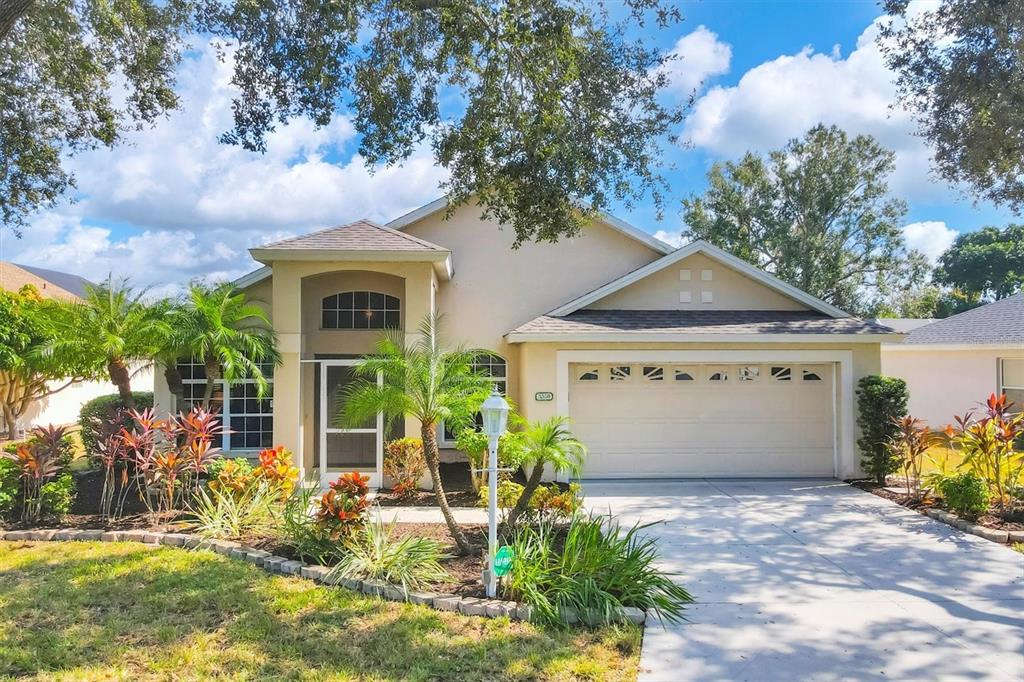 3350 Yonge Avenue, Unit 31 Sarasota, FL 34235 - Photo 1 of 39 a front view of a house with garden
