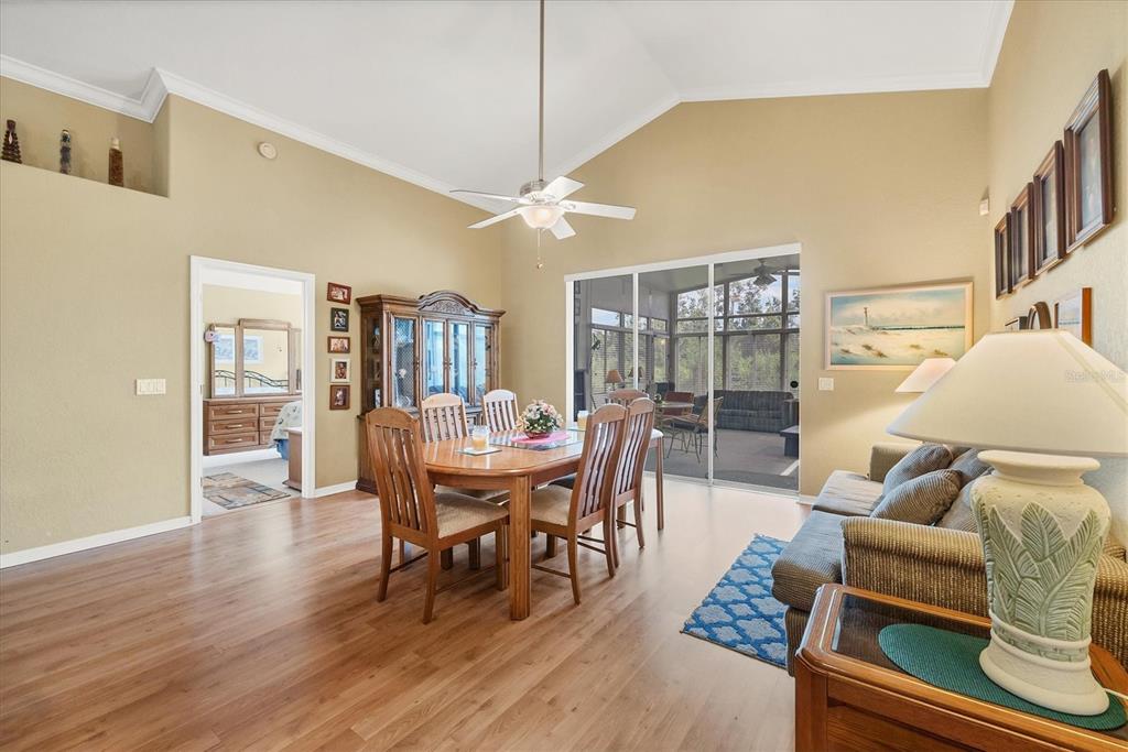 3350 Yonge Avenue, Unit 31 Sarasota, FL 34235 - Photo 12 of 39 a dining room with furniture a chandelier and wooden floor