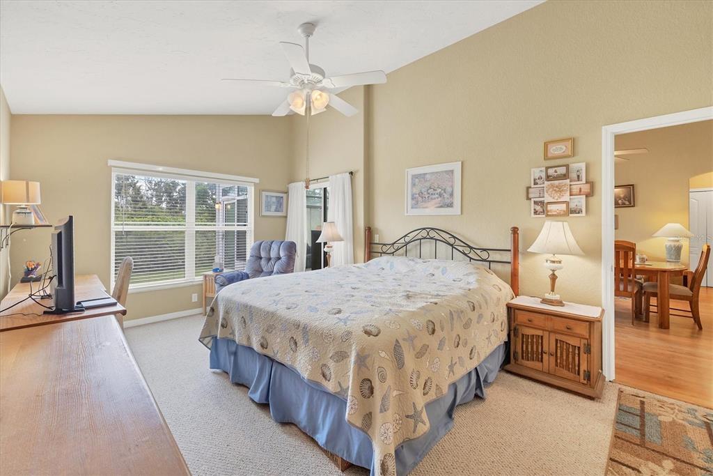 3350 Yonge Avenue, Unit 31 Sarasota, FL 34235 - Photo 13 of 39 a bed sitting in a spacious bedroom next to a window