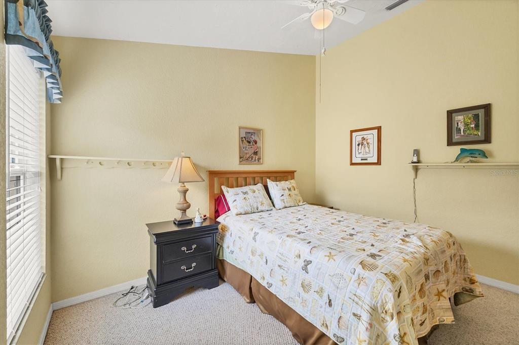 3350 Yonge Avenue, Unit 31 Sarasota, FL 34235 - Photo 20 of 39 a bedroom with a bed and a cabinets