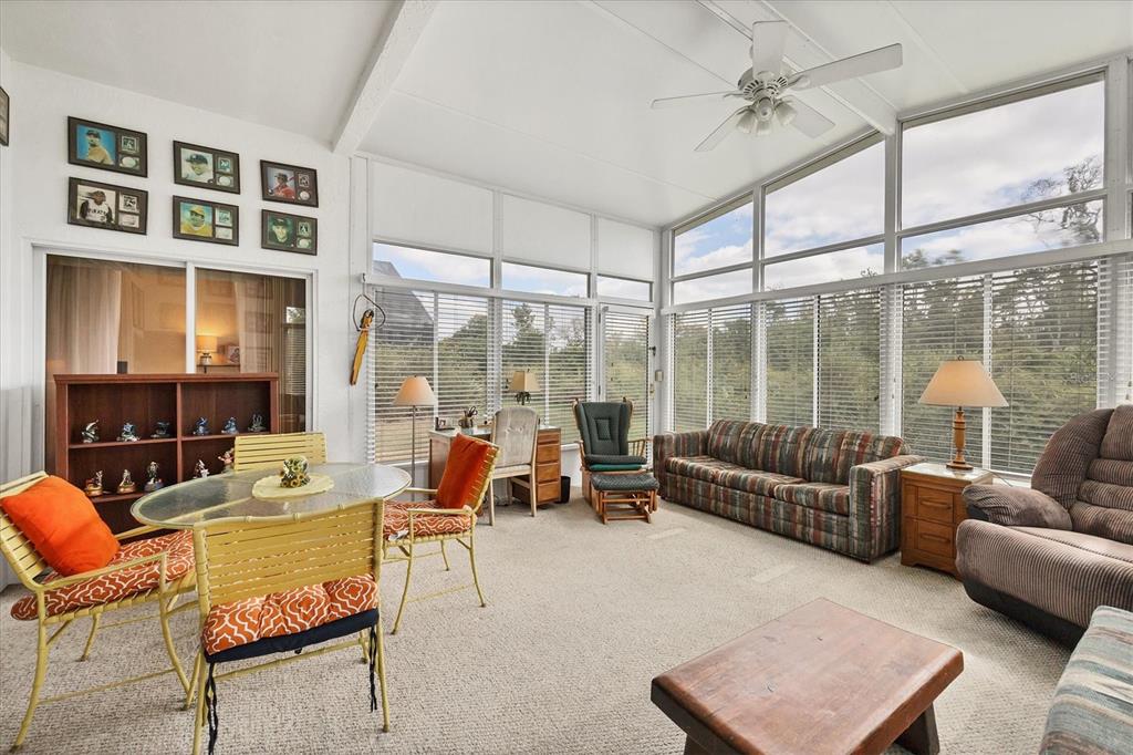 3350 Yonge Avenue, Unit 31 Sarasota, FL 34235 - Photo 23 of 39 a living room with furniture and a floor to ceiling window