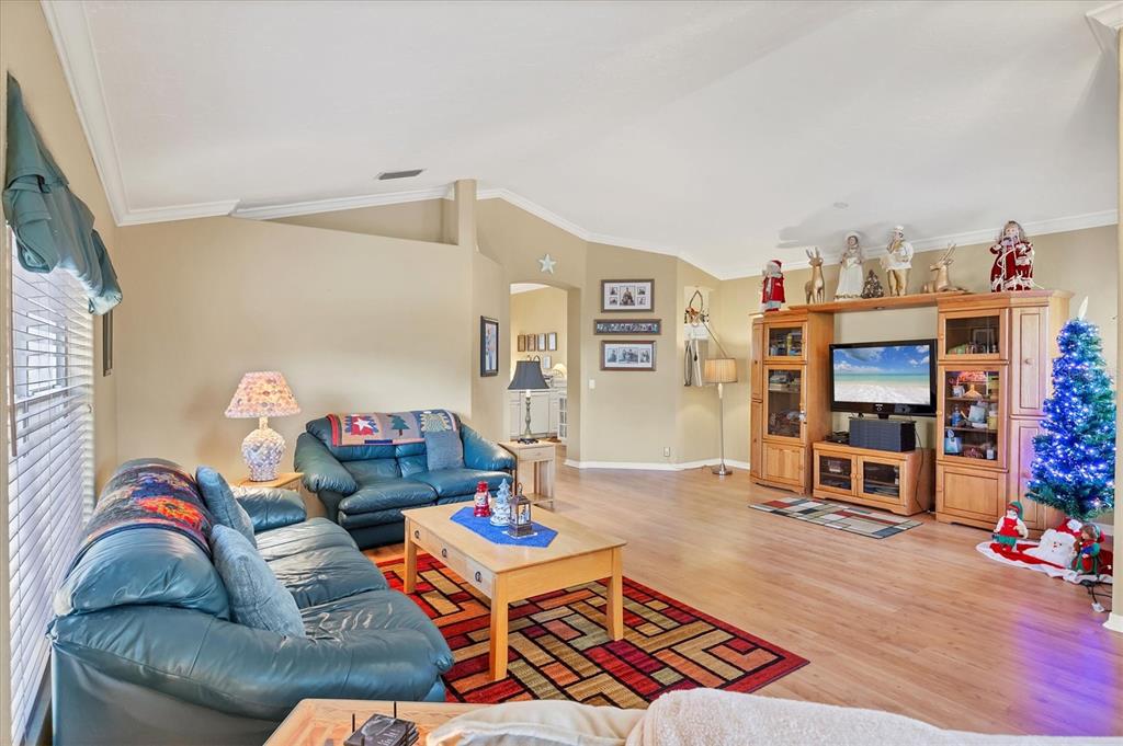 3350 Yonge Avenue, Unit 31 Sarasota, FL 34235 - Photo 5 of 39 a living room with furniture and a wooden floor