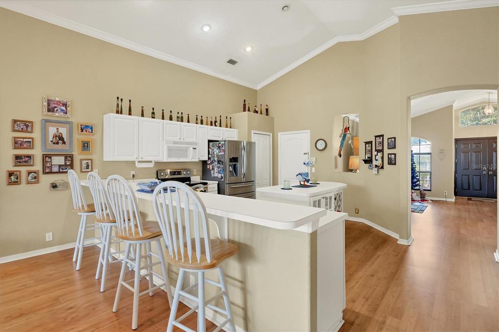 3350 Yonge Avenue, Unit 31 Sarasota, FL 34235 - Photo 8 of 39 a view of a dining room with furniture and wooden floor
