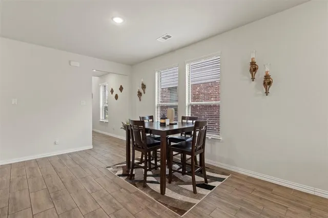a view of a dining room with furniture and window