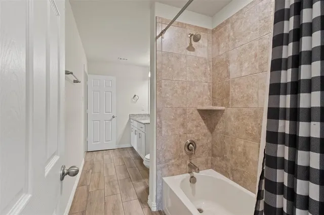 a bathroom with a bathtub and a shower