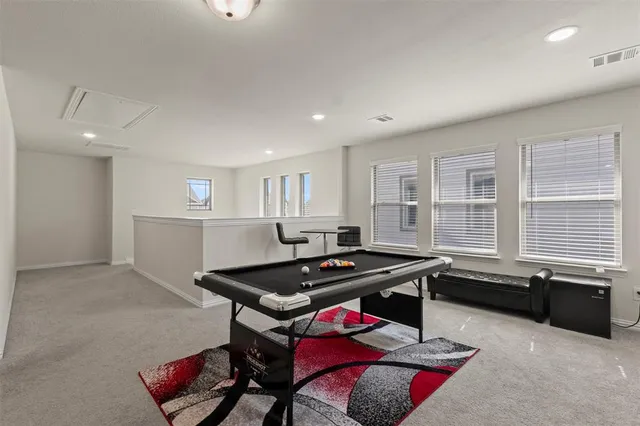 a view of a workspace with furniture and window