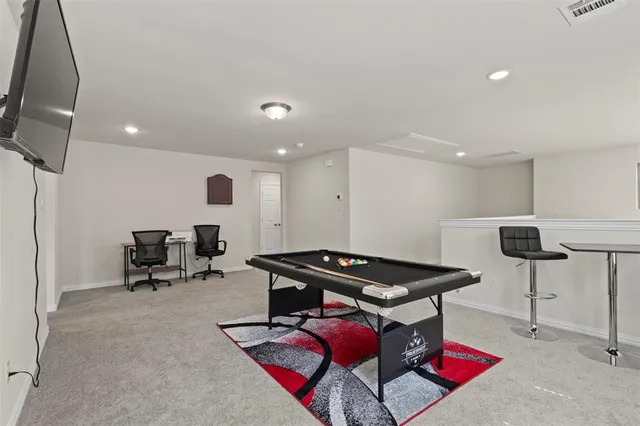 a room with furniture and air hockey table