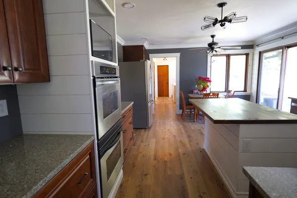 a kitchen with sink refrigerator and window