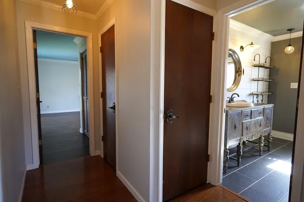 a view of a hallway with wooden floor