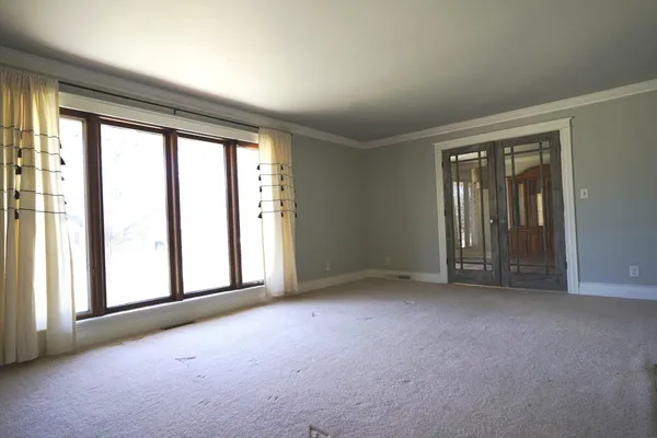 an empty room with windows and closet
