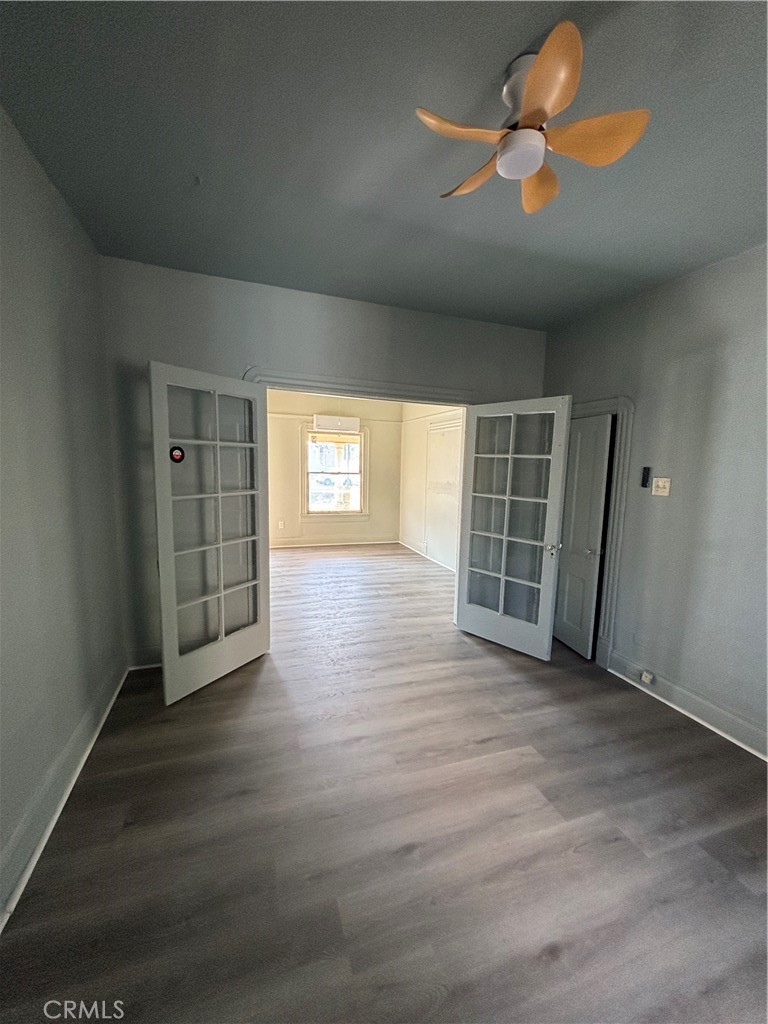 3499 Lemon Street Riverside, CA 92501 - Photo 13 of 32 an empty room with wooden floor and windows