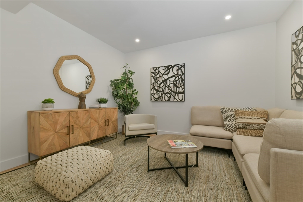 23 Eastman Road Somerville, MA 02143 - Photo 12 of 18 a living room with furniture and a wooden floor