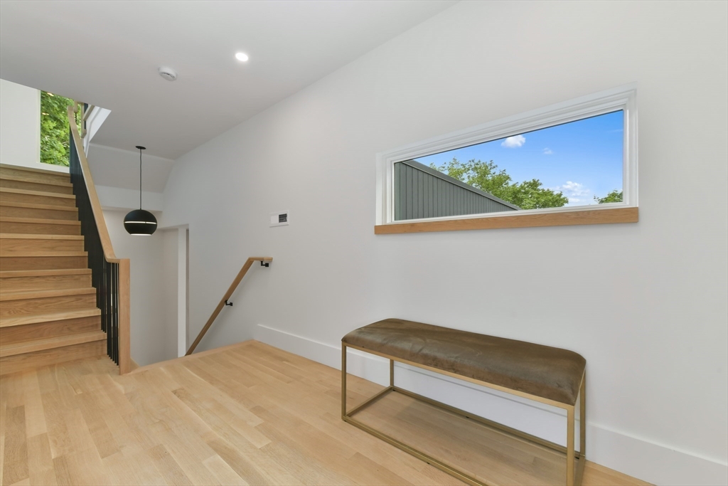 23 Eastman Road Somerville, MA 02143 - Photo 15 of 18 a bench sitting in a room next to a small white wall