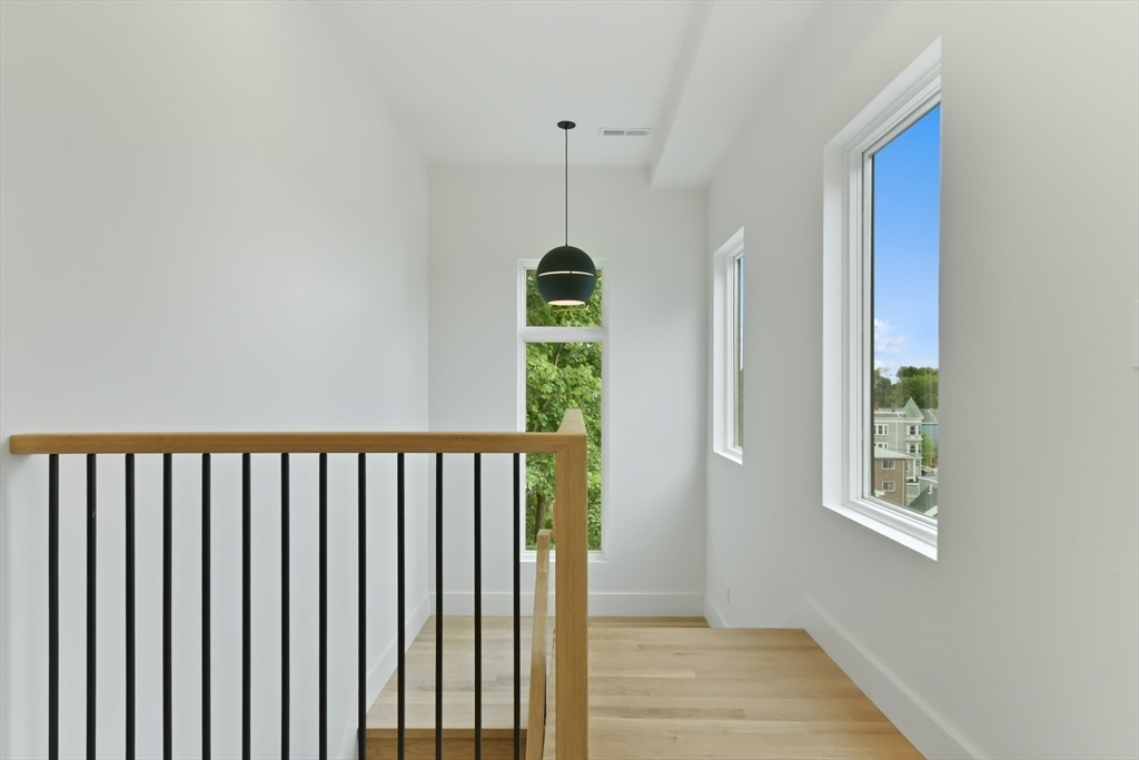 23 Eastman Road Somerville, MA 02143 - Photo 16 of 18 a view of a hallway with windows and stairs