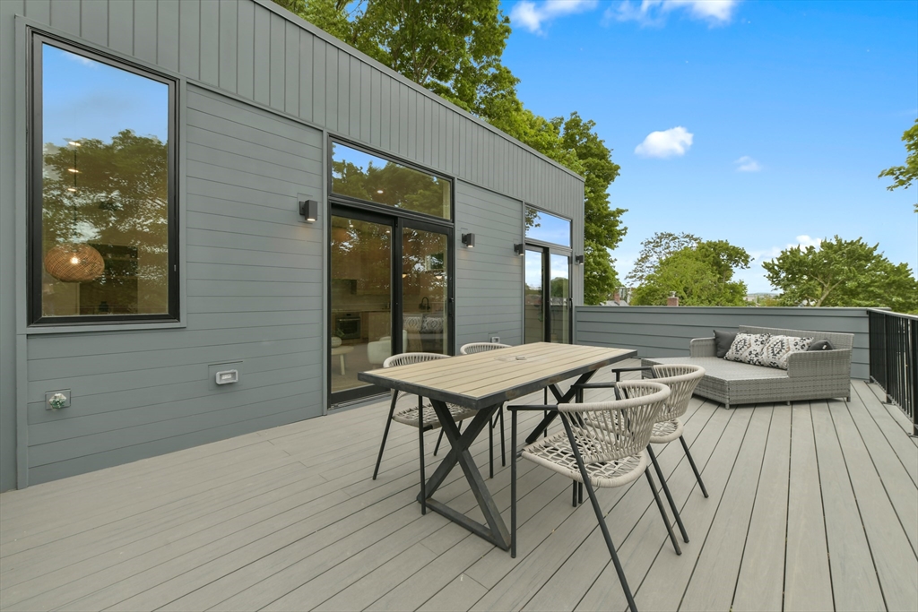 23 Eastman Road Somerville, MA 02143 - Photo 17 of 18 a table and chairs in front of a house