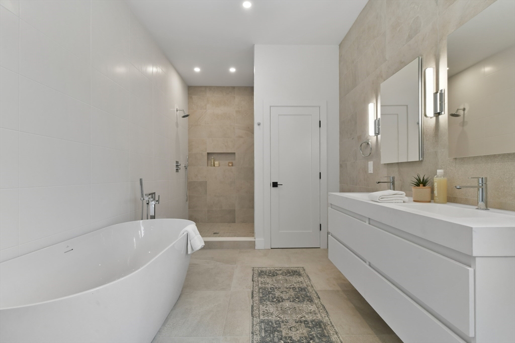23 Eastman Road Somerville, MA 02143 - Photo 7 of 18 a spacious bathroom with a tub sink and mirror