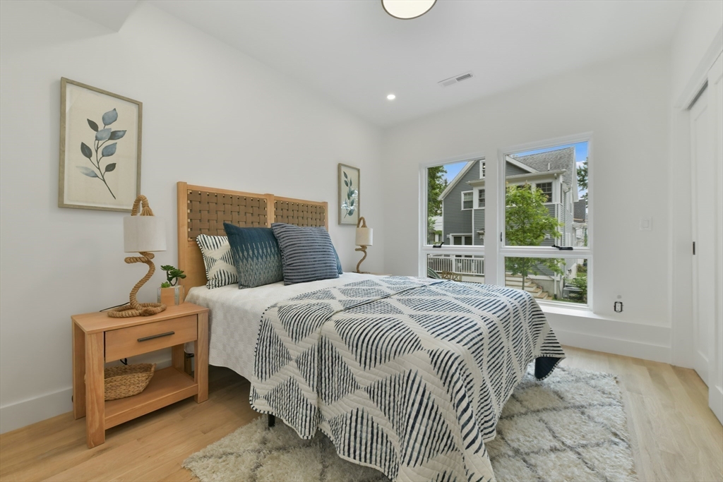 23 Eastman Road Somerville, MA 02143 - Photo 8 of 18 a bed sitting in a bedroom next to a window