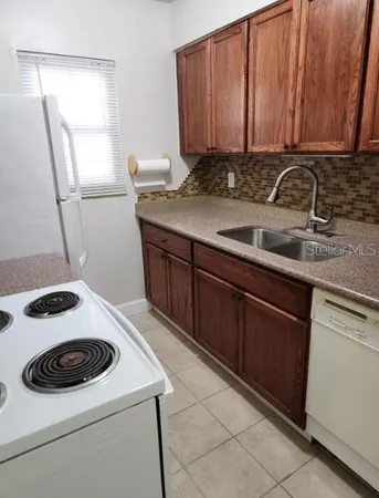 a kitchen with a sink stove and cabinets