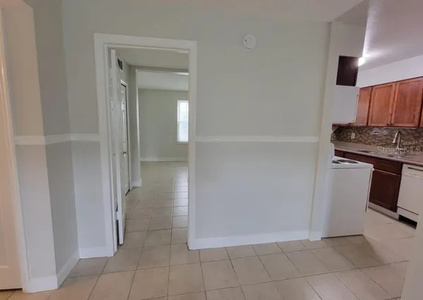 a view of a kitchen with a sink and a refrigerator