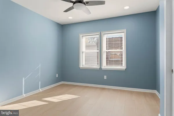 a view of a livingroom with a ceiling fan and window