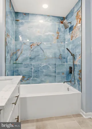 a bathroom with a bathtub and shower