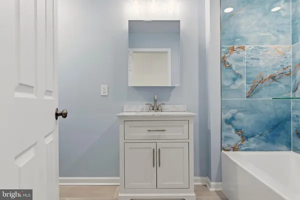 a bathroom with a sink a vanity and a mirror