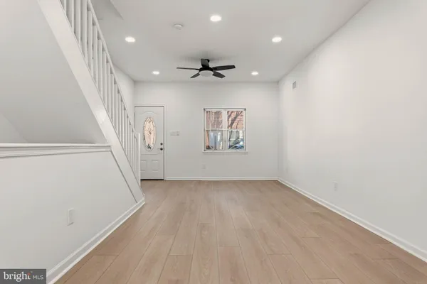 wooden floor in an empty room with a window