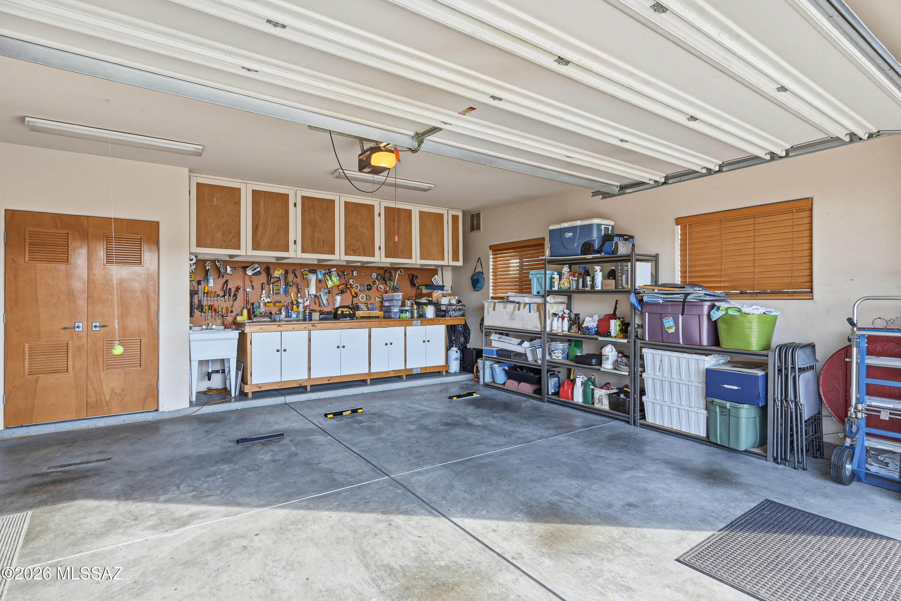 6060 North Abington Road Tucson, AZ 85743 - Photo 40 of 47 3-car garage with cabinets and sink