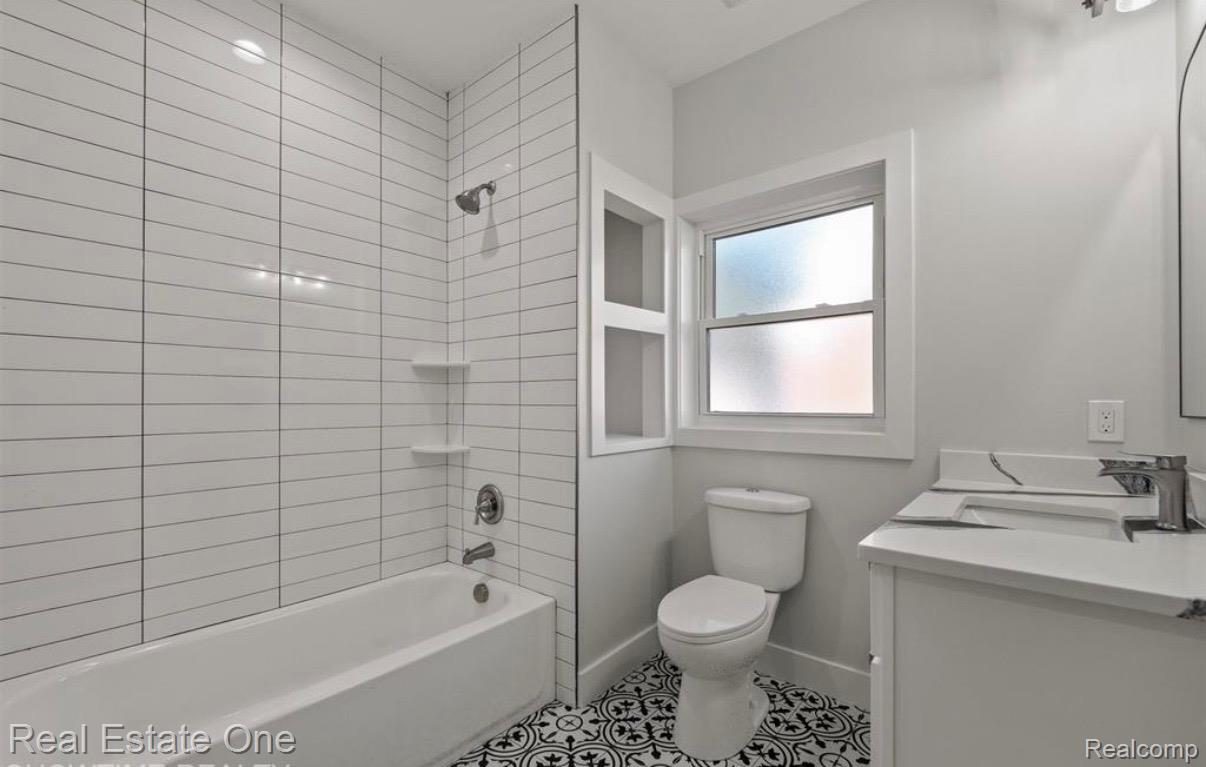 5636 Paris Street Sterling Heights, MI 48310 - Photo 11 of 37 Bathroom featuring shower / washtub combination, vanity, and light tile patterned floors
