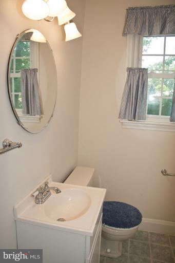 703 Sudbrook Road Pikesville, MD 21208 - Photo 2 of 15 a bathroom with a sink a toilet and a mirror