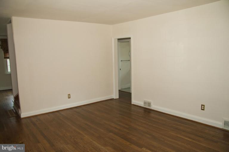 703 Sudbrook Road Pikesville, MD 21208 - Photo 12 of 15 an empty room with wooden floor