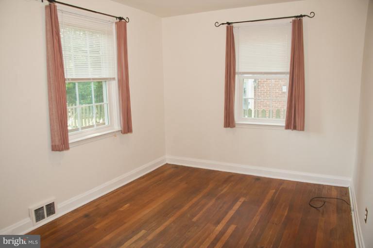 703 Sudbrook Road Pikesville, MD 21208 - Photo 5 of 15 an empty room with a window