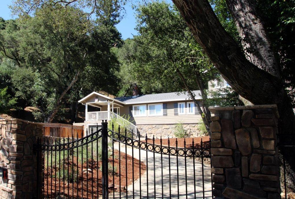 21390 Aldercroft Heights Road Los Gatos, CA 95033 - Photo 2 of 23 a front view of a house with a garden