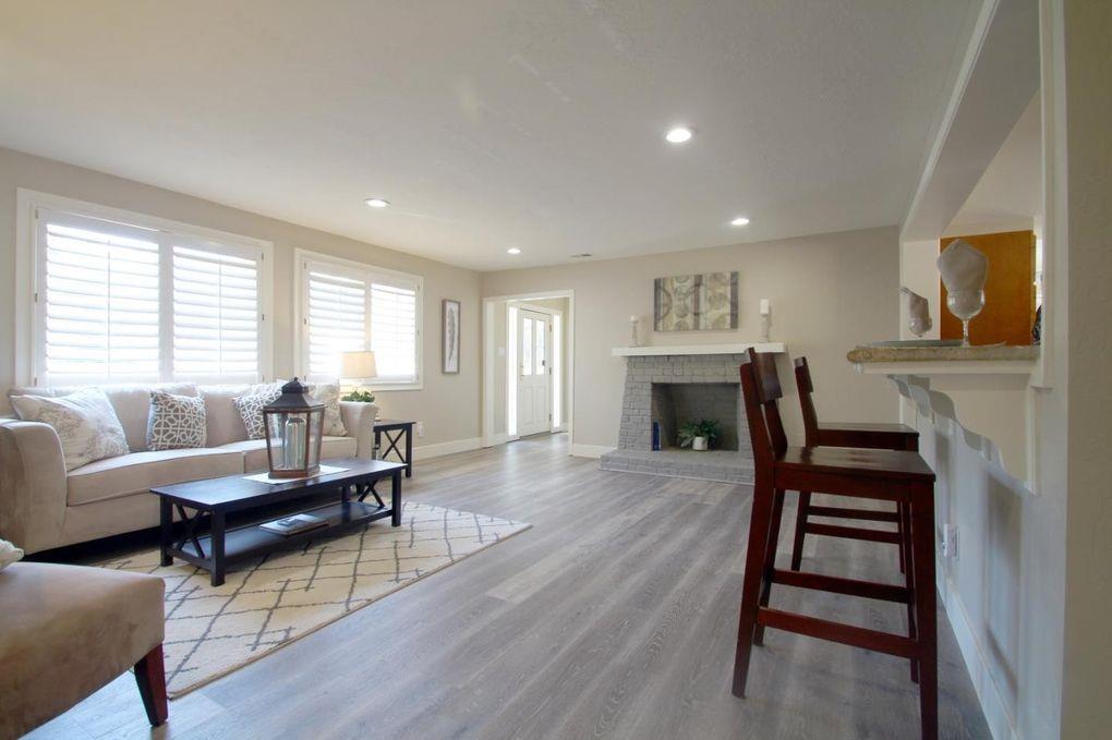 21390 Aldercroft Heights Road Los Gatos, CA 95033 - Photo 6 of 23 a living room with furniture a fireplace and wooden floor