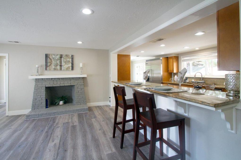 21390 Aldercroft Heights Road Los Gatos, CA 95033 - Photo 8 of 23 a kitchen with a table chairs and a fireplace