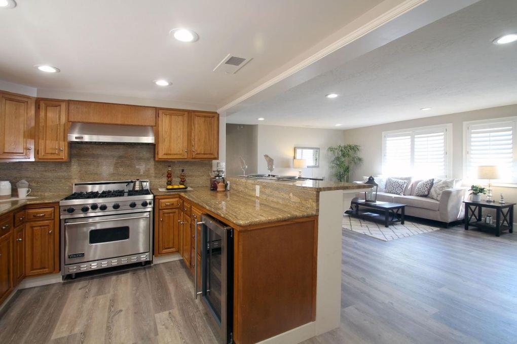 21390 Aldercroft Heights Road Los Gatos, CA 95033 - Photo 9 of 23 a kitchen with stainless steel appliances granite countertop a stove and a refrigerator