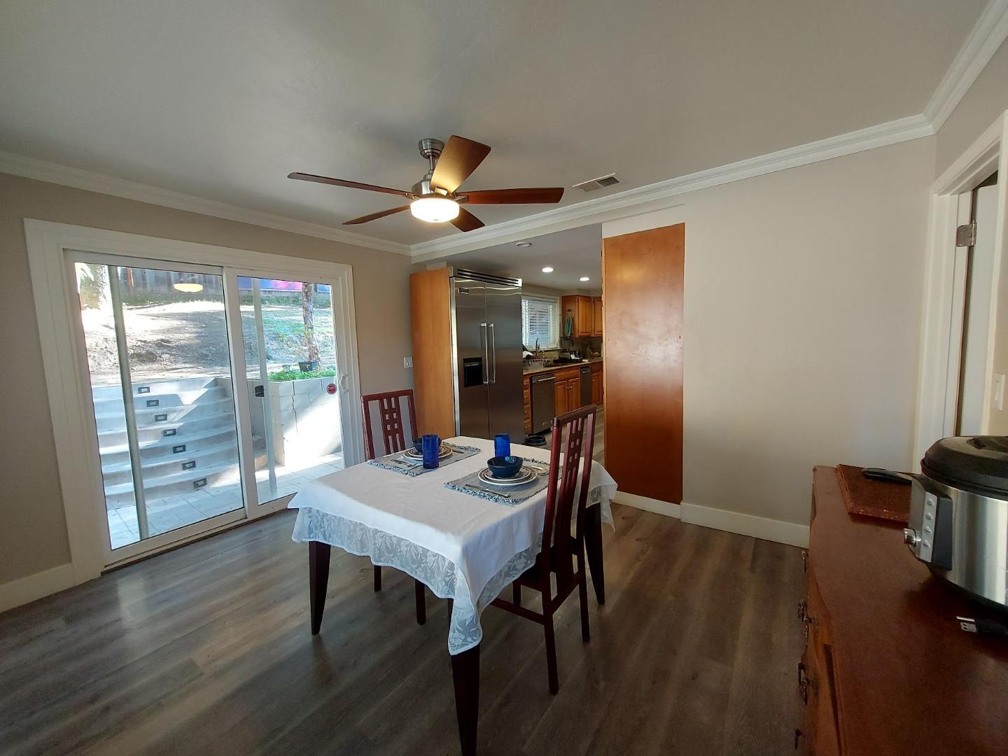 21390 Aldercroft Heights Road Los Gatos, CA 95033 - Photo 10 of 23 a view of a dining room with furniture window and wooden floor
