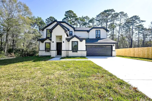 a front view of a house with a yard and garage