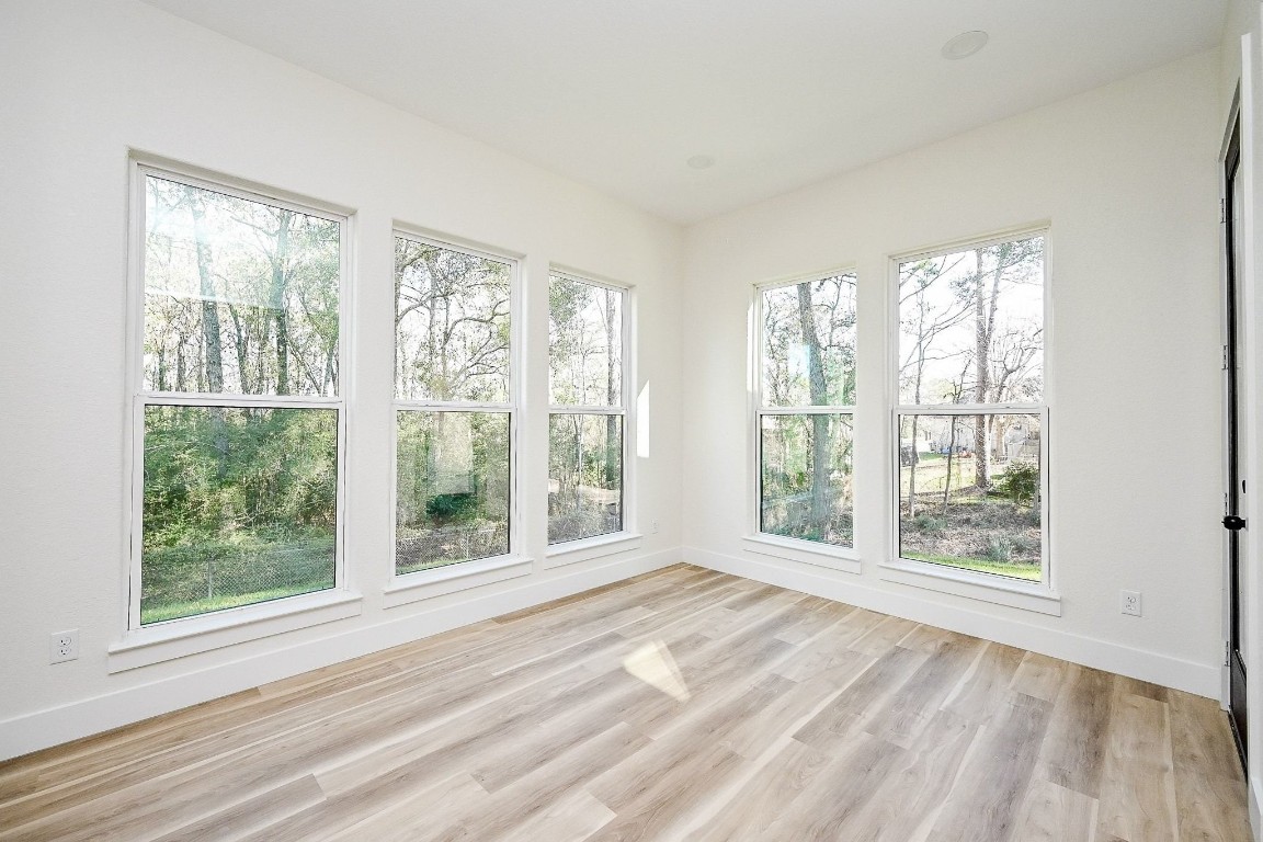21614 Lee Road Humble, TX 77338 - Photo 14 of 36 a view of an empty room with wooden floor and a window