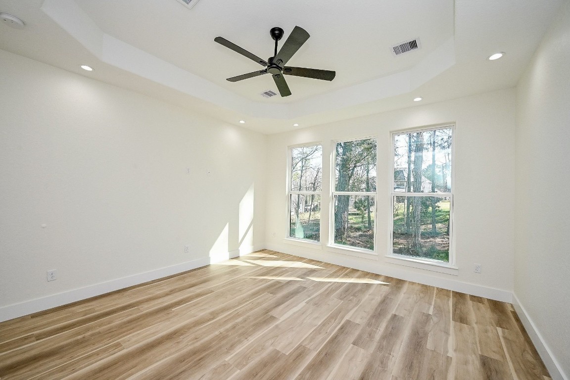 21614 Lee Road Humble, TX 77338 - Photo 15 of 36 an empty room with wooden floor fan and windows