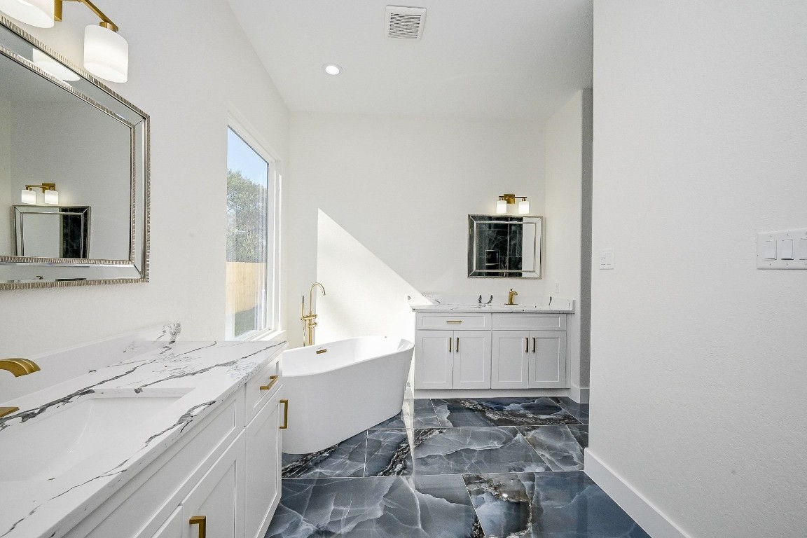 21614 Lee Road Humble, TX 77338 - Photo 17 of 36 a bathroom with a sink and a mirror