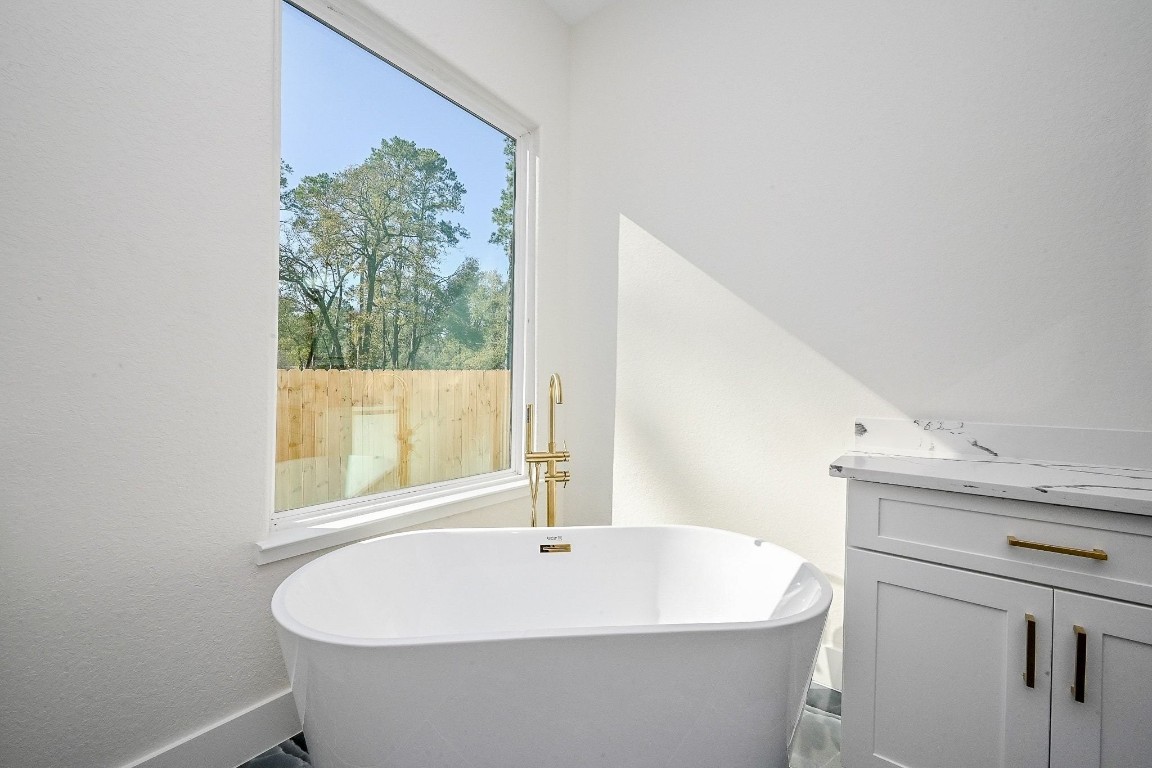 21614 Lee Road Humble, TX 77338 - Photo 19 of 36 a white bath tub sitting next to a window