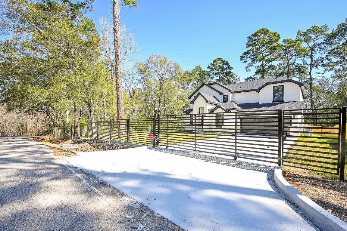 21614 Lee Road Humble, TX 77338 - Photo 32 of 36 a view of a house with a yard and garage