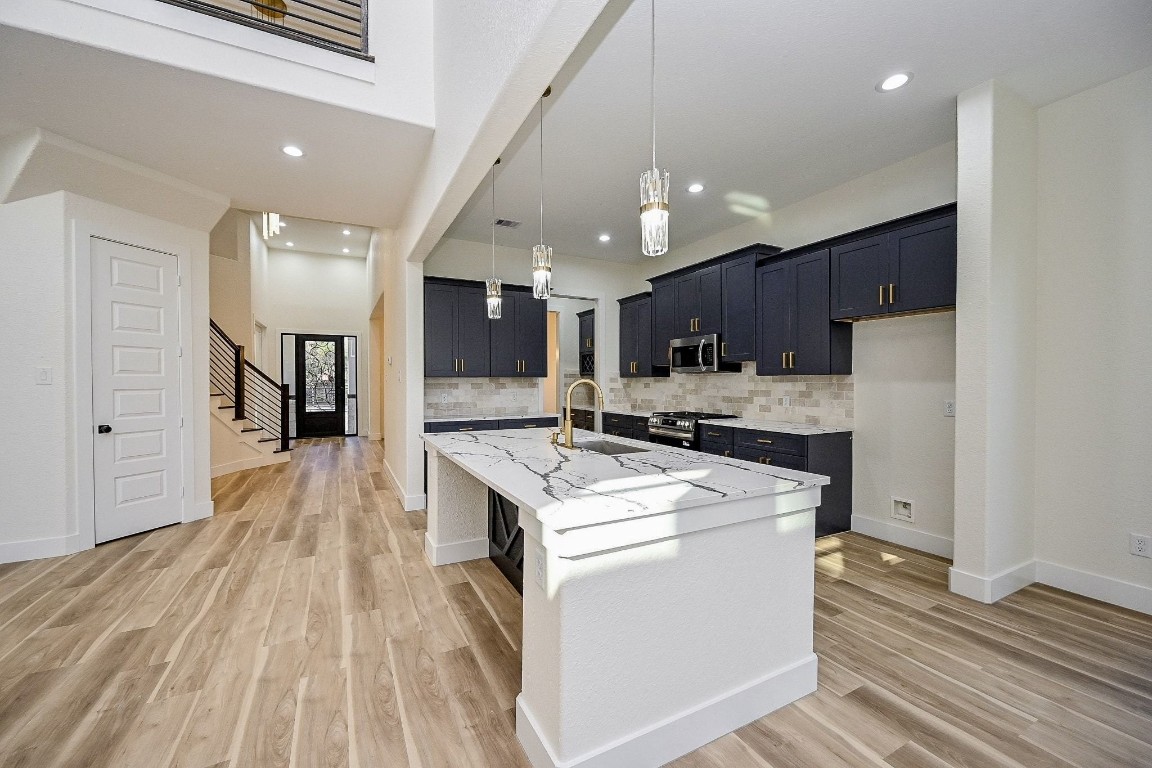 21614 Lee Road Humble, TX 77338 - Photo 4 of 36 a kitchen with a stove a refrigerator and a microwave oven