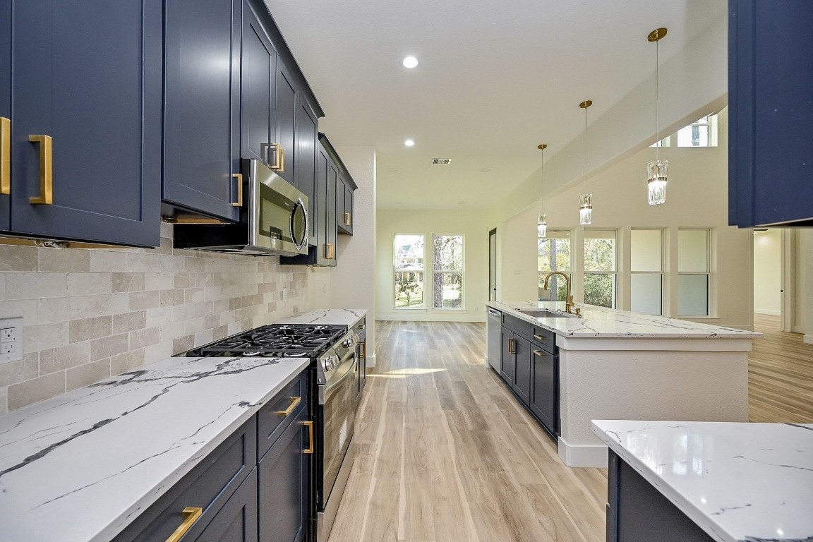 21614 Lee Road Humble, TX 77338 - Photo 8 of 36 a kitchen with stainless steel appliances granite countertop a sink stove and cabinets