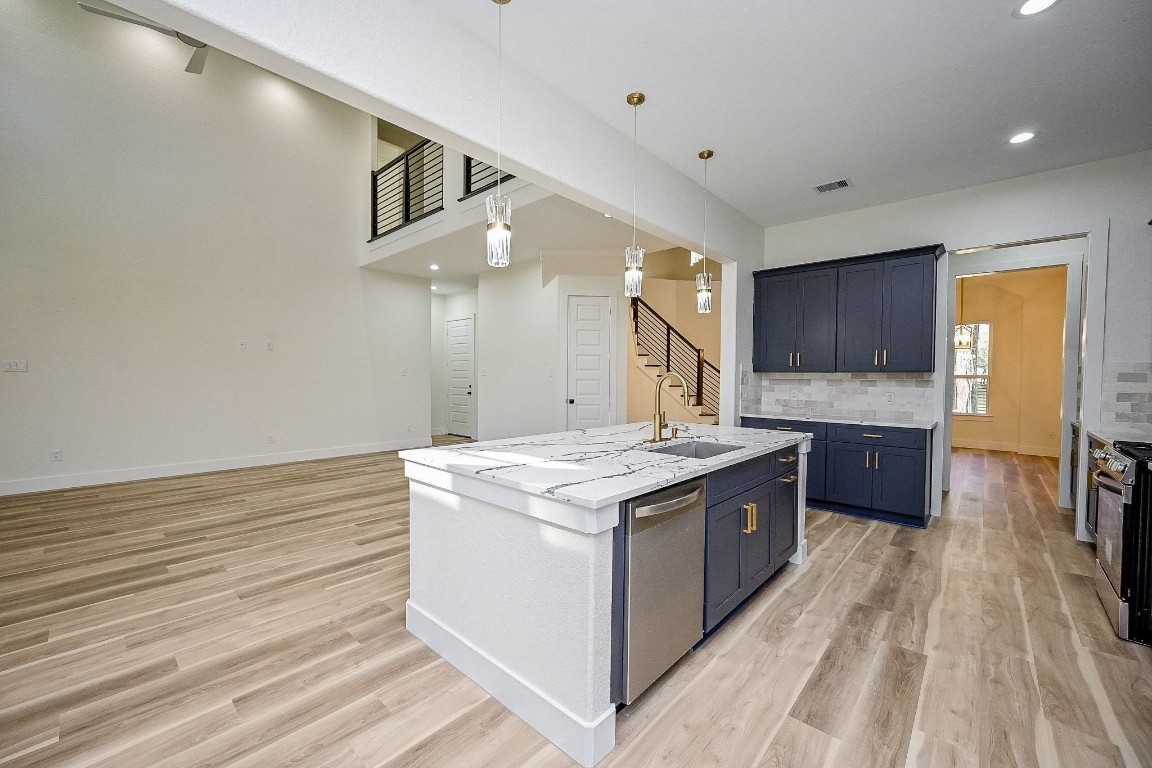 21614 Lee Road Humble, TX 77338 - Photo 10 of 36 a kitchen with stainless steel appliances granite countertop a stove and a sink