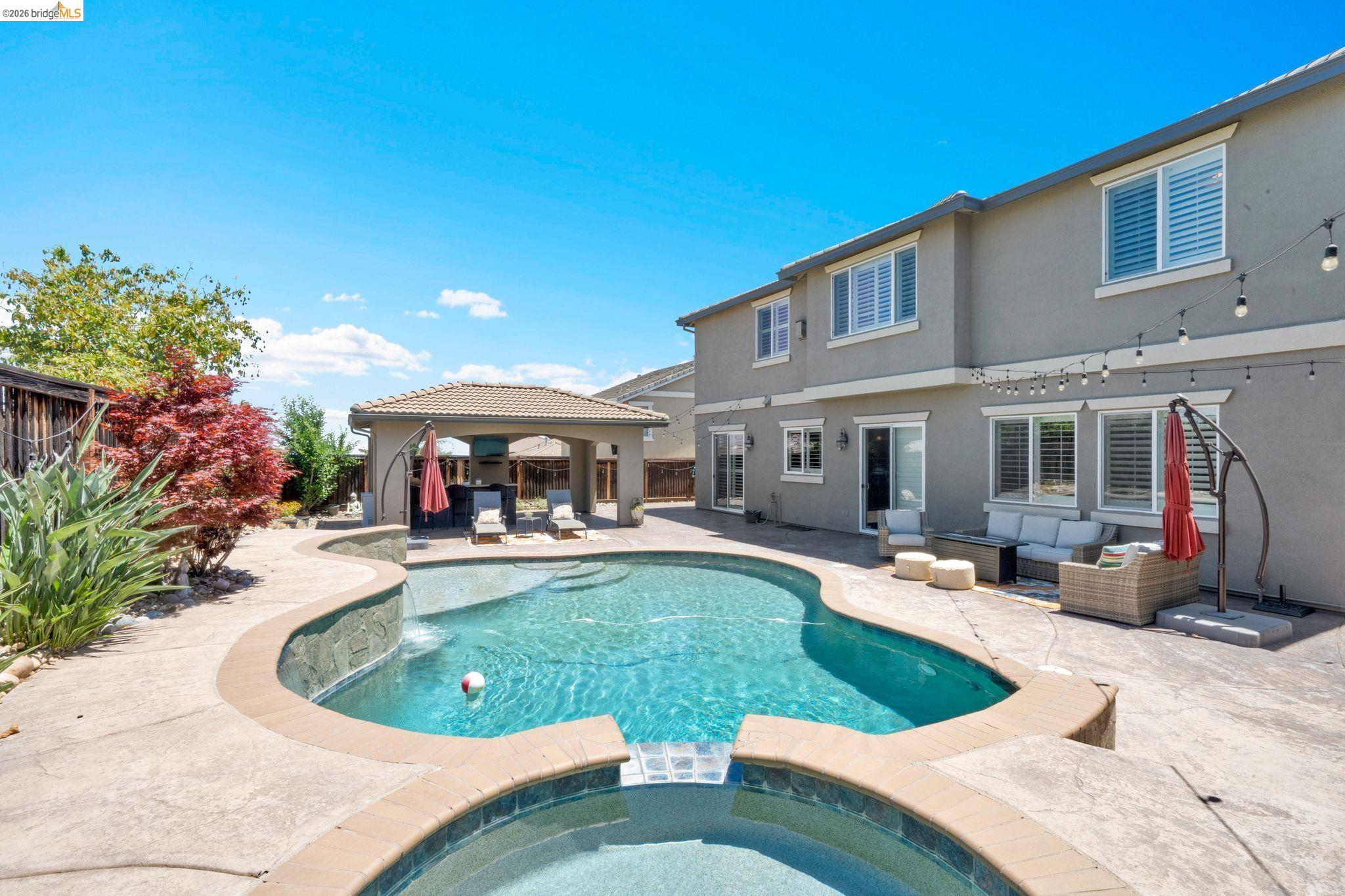 2513 Winged Foot Road Brentwood, CA 94513 - Photo 31 of 45 Backyard oasis featuring a freeform swimming pool with integrated spa, concrete decking, and a covered outdoor living area