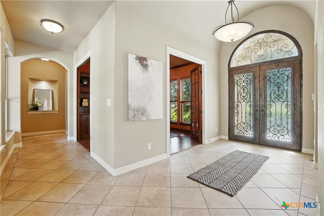 7607 Sky Loop Garden Ridge, TX 78266 - Photo 18 of 43 a view of a big room with a chandelier fan and windows