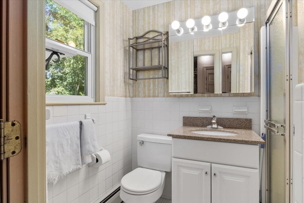 44 Ellis Street Medway, MA 02053 - Photo 29 of 42 a bathroom with a sink a toilet and a mirror