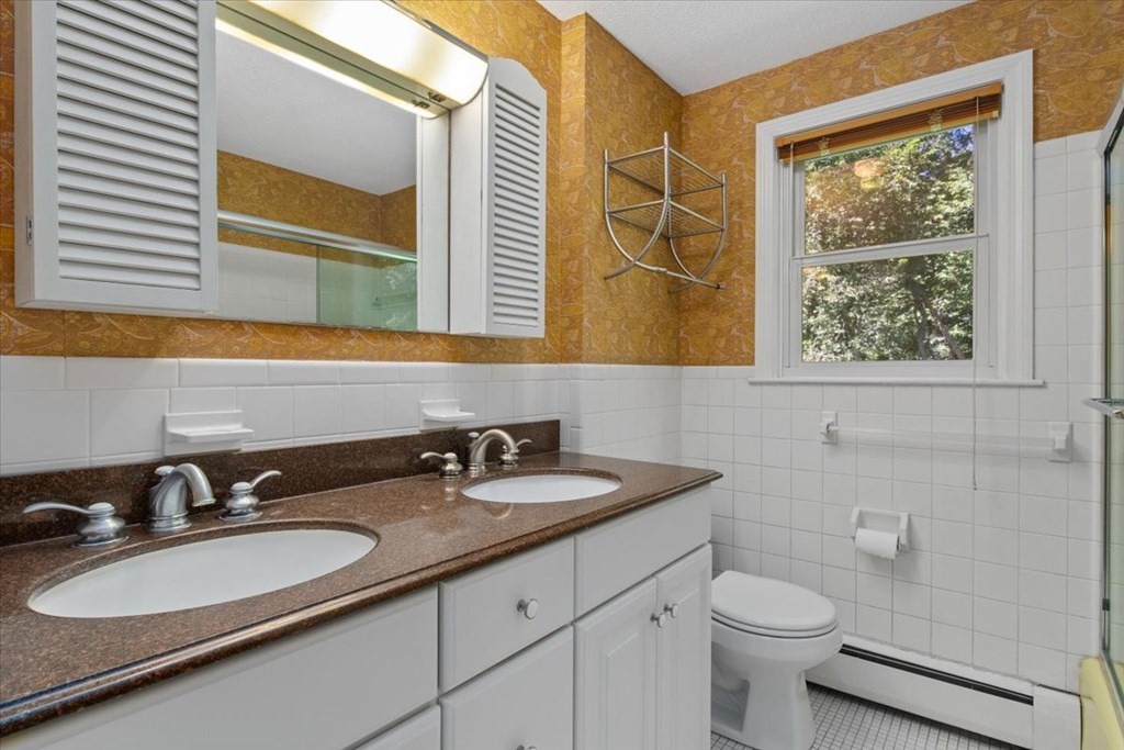 44 Ellis Street Medway, MA 02053 - Photo 30 of 42 a bathroom with a sink and a mirror